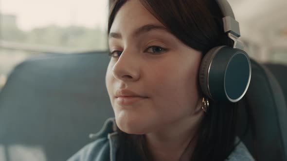 Dreamy Girl Face Listening Music with Headphones Closeup alt