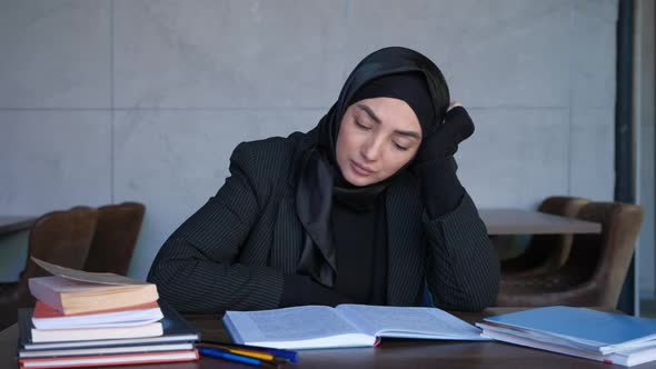 Young Muslim Woman in Hijab is Tired of Studying