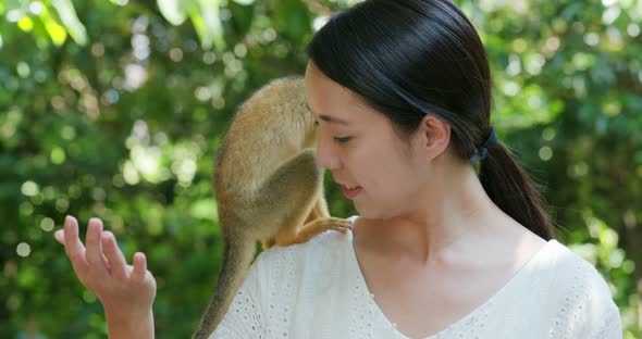 Woman tourist go to the park for visit  Squirrel Monkey alt