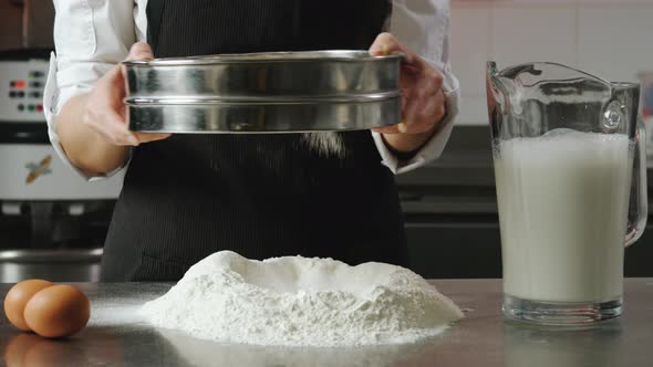 The Cook Sifts the Flour Through a Sieve