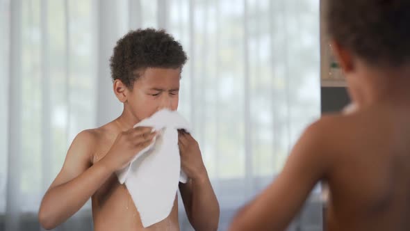 Little handsome boy wiping himself after taking shower, morning procedures, Stock Footage 
