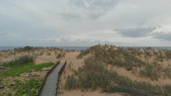 Walkway to Matadouro Beach. Aerial first-person alt