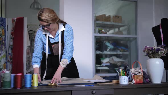 Female Tailor Making Patterns Working in Atelier alt