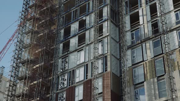 Construction site at Sheffield city centre with red crane in background, South Yorkshire alt
