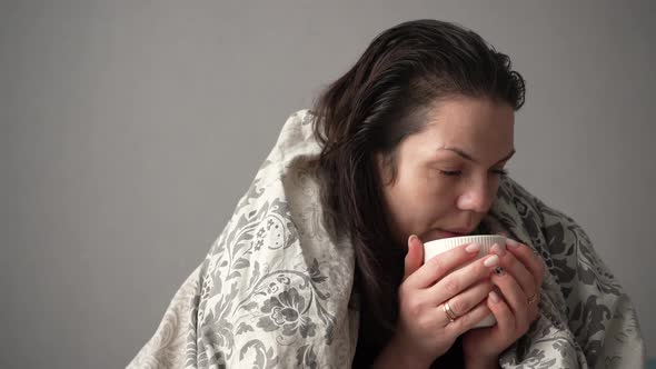 Portrait of Sick Tired Woman Patient with White Cup Sitting on Sofa