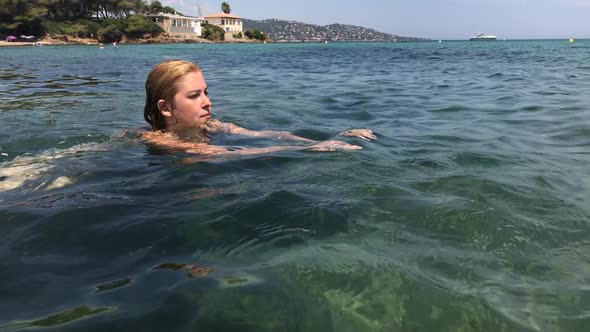 Swimming in blue French coast  water  slow-mo 1920X1080 HD footage - Female in  crystal clear sea sl alt