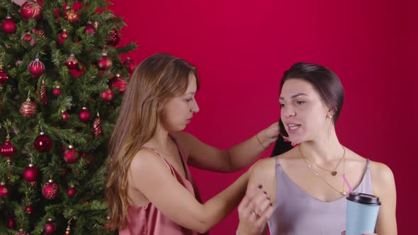 Couple of Lesbians Brushing Their Hair at Christmas Tree Discussing News