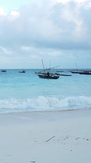 Vertical Video Boats in the Ocean Near the Coast of Zanzibar Tanzania alt