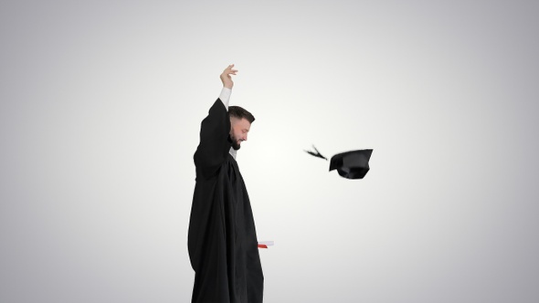 Happy and Excited Graduate Male Student Throws Hat in The alt