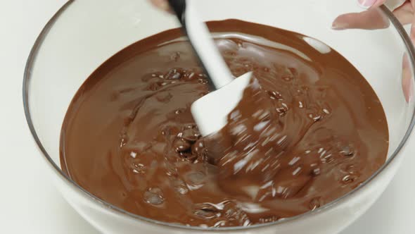 Closeup Stirring Mixing Dark Melting Chocolate in Glass Bowl, Slow Motion