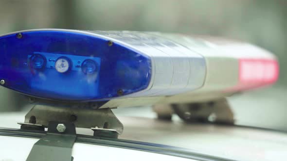 Flashing Flasher on the Roof of a Police Car. Blinker. Close-up. alt