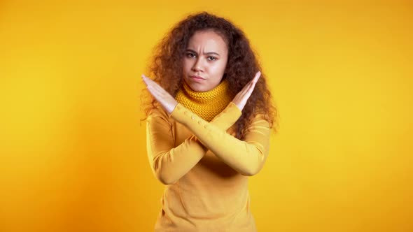 Cute Girl Disapproving with No Crossing Hands Sign Make Negation gesture, Denying alt