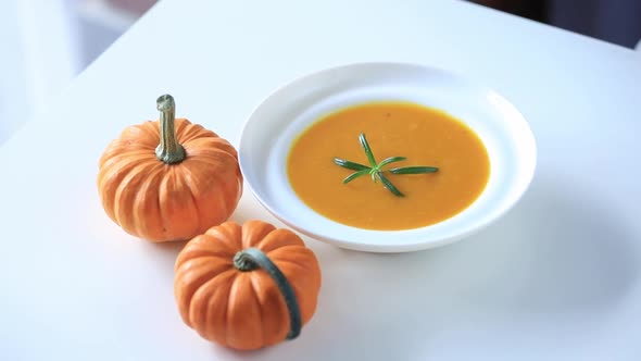 Pumpkin soup and pumpkin on a table. Top view