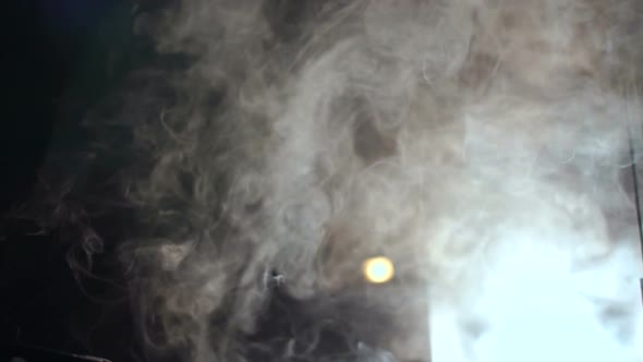 White Smoke From a Smoke Machine in the Dark alt