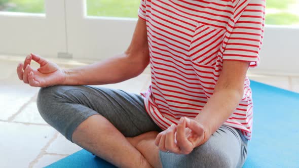 Parents and kids having fun while watching television in living room alt