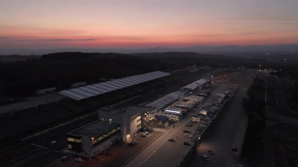 Aerial view of Hungaroring paddock filled with trucks, after sunset