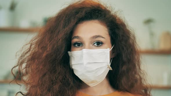Face of a Woman Wearing a Safety Mask in a Front View. Lockdown Concept, Coronavirus Pandemic. alt
