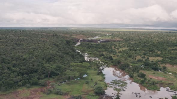 River and savanna wildlife conservation reserve in Laikipia, Kenya. Aerial drone view alt
