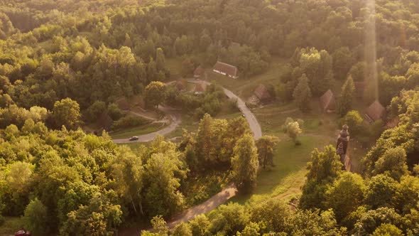 Aerial View of Very Small Village Amoung Forest Trees alt