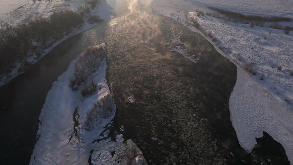 Early Morning Aerial View on the Frozen River Scenic Landscape at Sunny Winter Day  Drone Video alt
