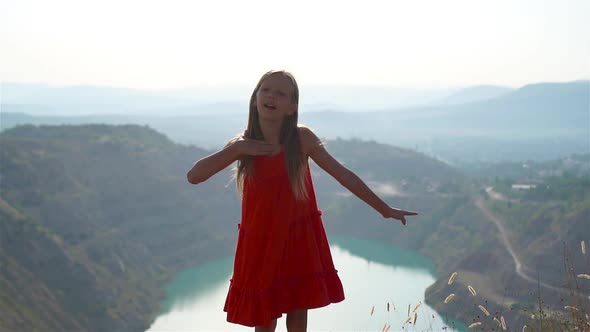 Little Girl on Top of a Mountain Enjoying Valley View