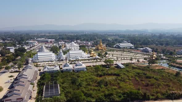 Aerial of Large White Buddhist Temple Complex alt