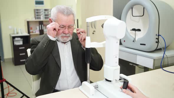 Ophthalmologist Examination of Elderly Man on Corneo Topographer alt