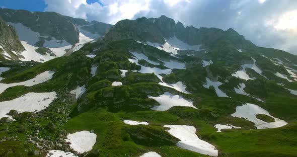 Aerial View Mountain Pass With Glaciers And Green Grass In Mountains Of Caucasus. alt
