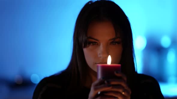 Mysterious Woman Is Looking Into Candle Burning at Night Prophecy and Fortune Telling alt