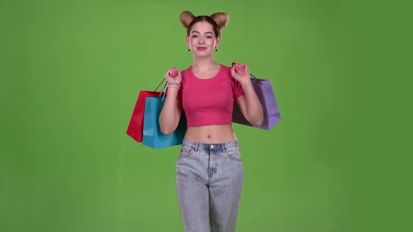 Teenager Goes Shopping with Bags in His Hands. Green Screen. Slow Motion alt