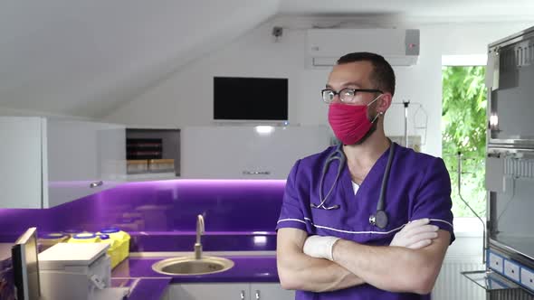 Handsome veterinarian with red mask on face, pet clinic. alt