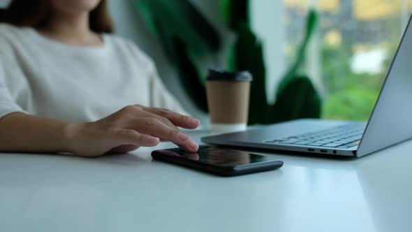 Closeup of a woman touching and scrolling on smart phone screen