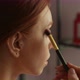 Macro Closeup of Focused Redhead Young Woman Model Applying Eyeshadow on Upper Eyelid Using Soft - VideoHive Item for Sale