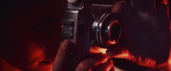 Photographer adjusting focus ring alt