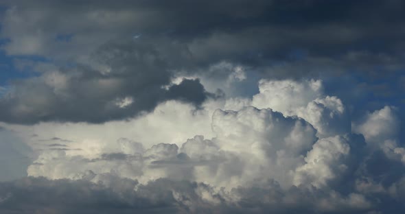 Cumulus clouds fast flying sky timelapse.