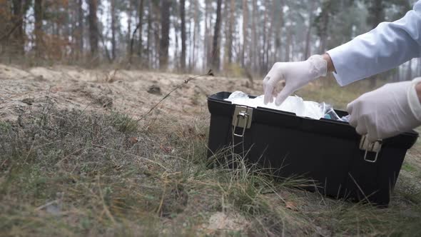 In the Forest, an Ecologist Takes Samples of Plants and Puts Them in a Test Tube