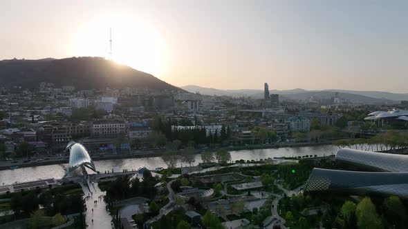 Tbilisi, Georgia - April 20 2022: Aerial view of Tbilisi city central park and Bridge of Peace alt