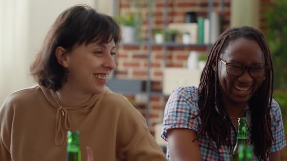 Diverse Group of Friends Having Fun with Beer Bottles at Home alt