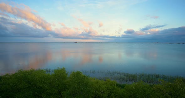 Beautiful Summer Sunset Reflecting From the Calm Sea Surface in Panoramic Photo