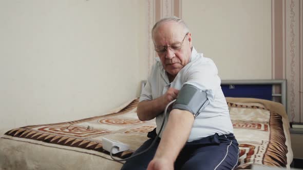 Elderly Man Measuring Blood Pressure alt
