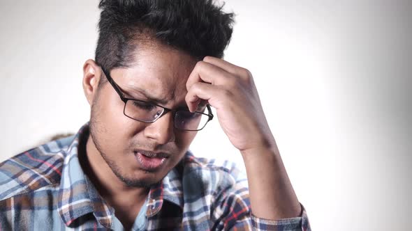 Young Man Suffering Headache Close Up alt