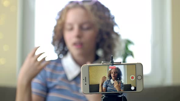 Teenager Social Media Vlogger Shooting Vlog Streaming Online Podcast on Mobile Phone alt