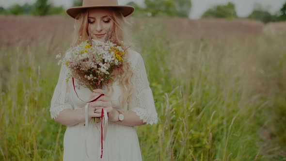 Smiling Boho Hippie Girl Holding Flowers Outdoors alt
