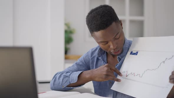 Confident Handsome Man Pointing at Graph Talking in Slow Motion at Laptop Web Camera alt