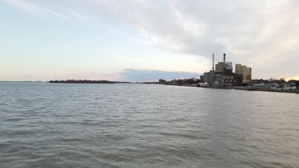 Industrial factory buildings on coastline of Detroit river in Wyandotte, Michigan. Aerial low altitu alt