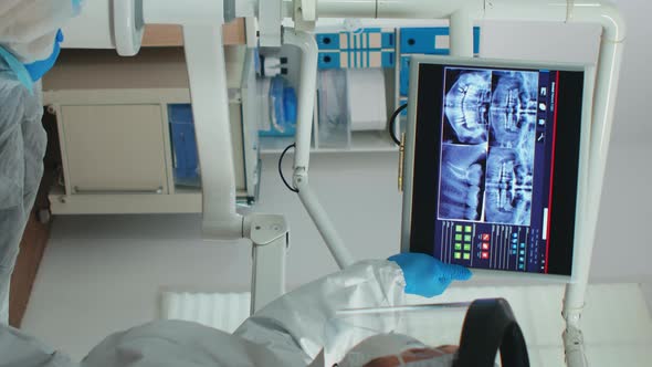 Vertical Video Doctor with Face Shield Pointing on Stomatological Monitor alt