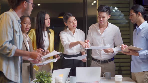Asian young business people group having a discussion meeting and brainstorming in office workplace. alt