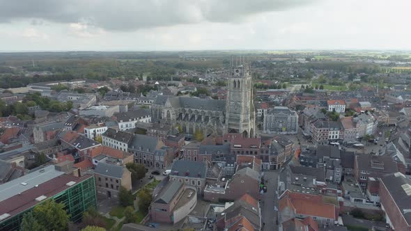 Cityscape of Tongeren and Basilica of Our Lady, Belgium. Aerial flying backwards alt