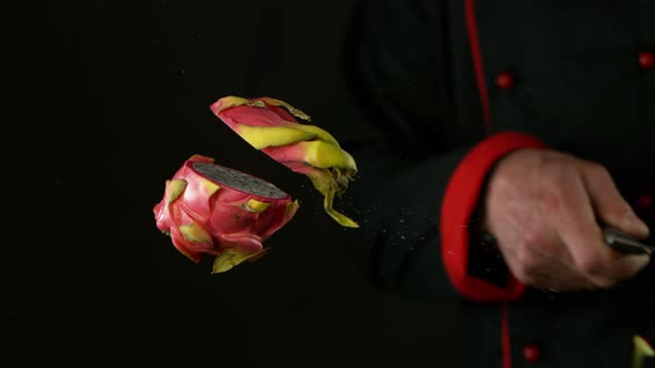 Super Slow Motion Shot of Chef Chopping Pitahaya in the Air at 1000 Fps alt
