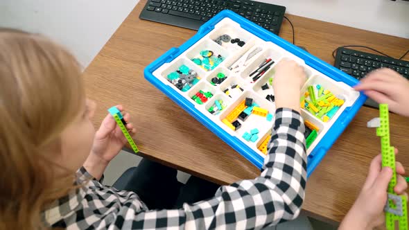 Children Using Building Kit in Classroom alt
